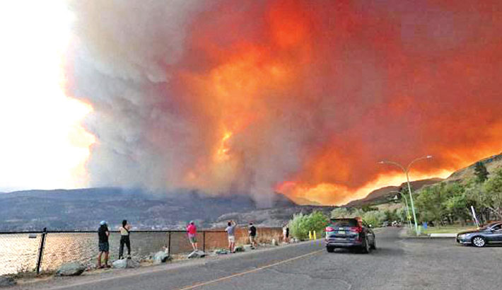 Tens of thousands flee western Canada wildfires