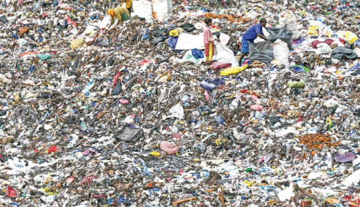 Rag pickers look for recyclable materials at a disposal site, in Chennai, Tamil Nadu, India on Monday. AFP PHOTO