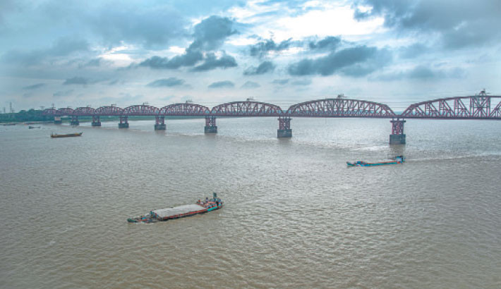 Clouds gather in the sky, hinting at imminent rain, as sand-laden cargoes glided across the Padma River beneath the Lalon Shah Bridge—together painting a serene, almost poetic portrait of nature and movement. The snap was taken on Friday. -MONIRUL ISLAM MARUF