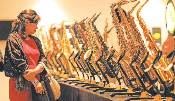 A woman looks at saxophones displayed for sale during the Indonesia Tiup Festival in South Tangerang on 19 July 2025. Photo: AFP