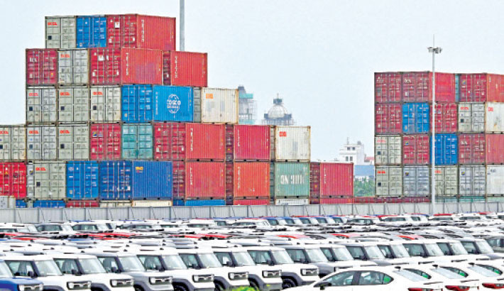 Cars and stacked shipping containers are seen at a cargo yard in Hai Phong, Vietnam, on Sunday. PHOTO: AFP