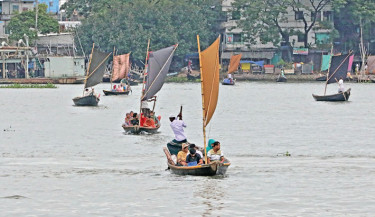 Sails catch the wind as boats glide across the Buriganga River, carrying passengers over waters that are usually murky, now brightened by the season’s rains. The photo was taken in  he capital’s Shyampur on Saturday.  -  KAMRUL ISLAM RATAN