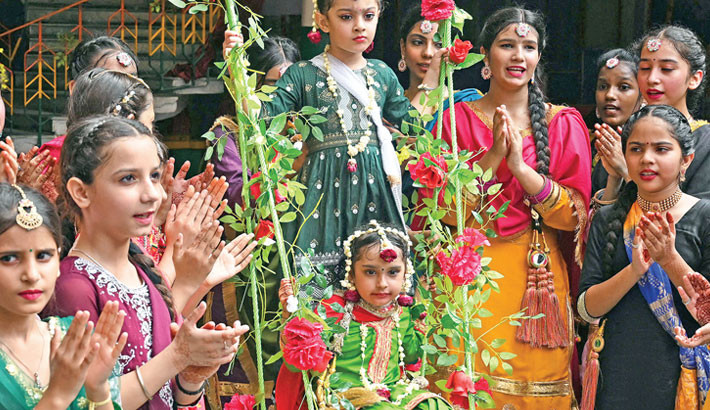 Schoolgirls in traditional Punjabi dress enjoy a swing and sing Giddha songs during ‘Green Day’ also Teej festival celebrations at a school in Amritsar, Punjab, India on Saturday.-AFP PHOTO