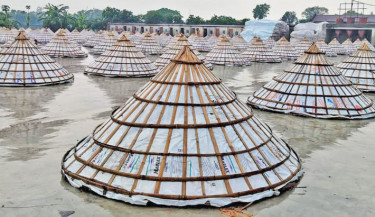 Conical covers protect paddy from rain at a rice mill in Brahmanbaria’s Ashuganj, as continuous rainfall disrupts drying activities. Persistent rain over the past few days has brought rice production to a halt in this key rice-producing hub. The photo was taken on Thursday. -Focus Bangla