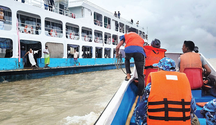 Coast Guard members provide emergency medical treatment to an ailing passenger aboard a launch in the middle of the river in Chandpur on Thursday.-Coast Guard Photo