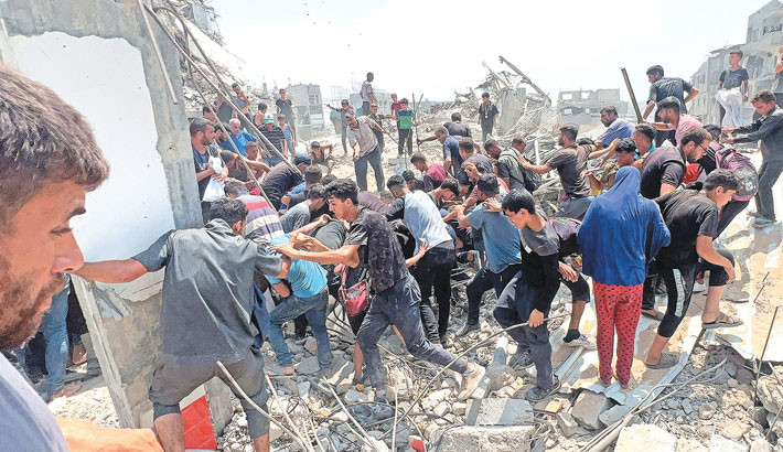 Palestinians hustle around a humanitarian parcel dropped by a military aircraft in Jabalia in the northern Gaza Strip on Saturday.-AFP PHOTO
