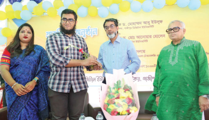 Gazipur Digital University Vice Chancellor Prof Dr Mohammad Abu Yousuf hands over a flower to a new student, welcoming him at the reception programme of newly admitted honours first year students on the campus on Monday. – Daily Sun Photo