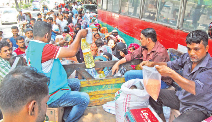 People crowd in front of a Trading Corporation of Bangladesh (TCB) truck on Abdul Gani Road in the capital to buy oil, lentils, and sugar. The photo was taken on Monday. 

PHOTO: FOCUS BANGLA