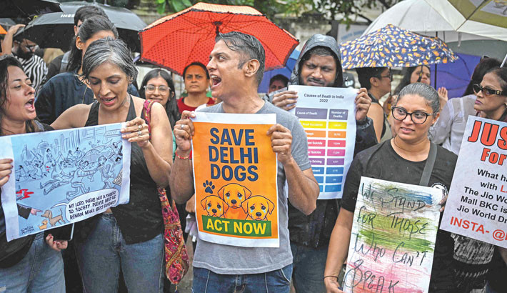 Residents hold placards during a protest in Mumbai on Thursday, against India's Supreme Court order of the removal of stray dogs from the capital, citing public safety concerns after a surge in dog bites.  -  AFP PHOTO