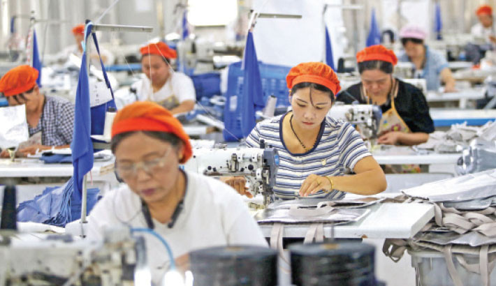Women work at a bag manufacturing plant in Linhuan Town, eastern China’s Anhui Province on Thursday. PHOTO: AFP
