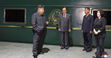 Kim rides his trademark green train to China