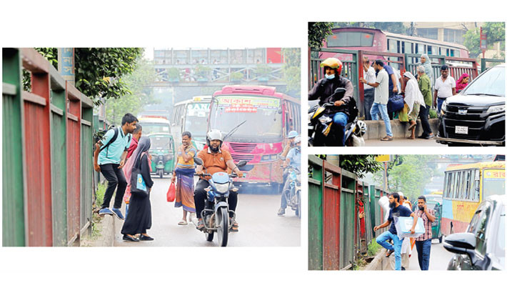 Ignoring a footbridge just yards away, pedestrians dangerously cross under a broken iron railing while vehicles rush past on the busy road. This photo from the capital’s Natun Bazar area highlights a serious safety hazard. -REAZ AHMED SUMON
