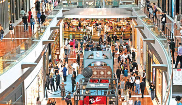 Visitors walk through the Marina Bay Sands shopping mall in Singapore on Thursday. PHOTO: AFP
