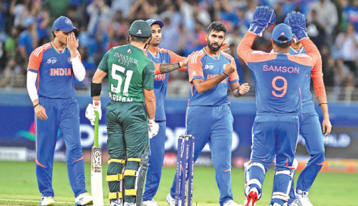 India's players celebrate after taking the wicket of Pakistan's Mohammad Haris during the Asia Cup 2025 match between India and Pakistan at the Dubai International Stadium on Sunday. 

AFP Photo
