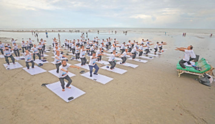 Uttara Yoga Society holds a yoga session on Cox’s Bazar sea beach on Sunday. -Daily sun Photo