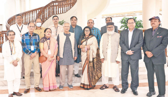 Members of the Hindu community pose for a photo with Prof Muhammad Yunus at the State Guest House Jamuna in Dhaka on Monday on the occasion of Durga Puja.-PID Photo