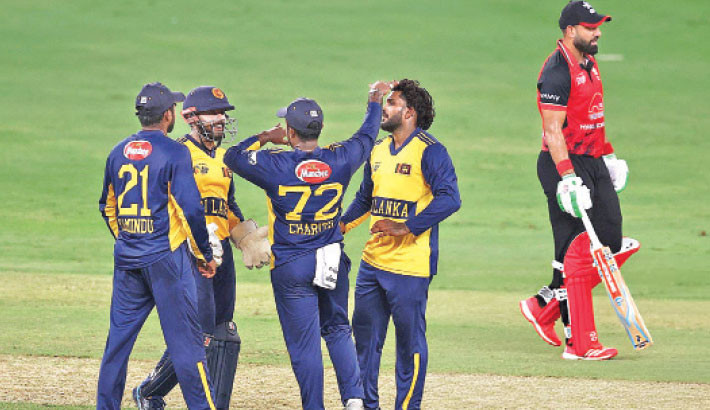 Sri Lankan cricketers celebrate the wicket of Hong Kong's Babar Hayat during the Asia Cup match at the Dubai International Stadium on Monday. 

AFP Photo