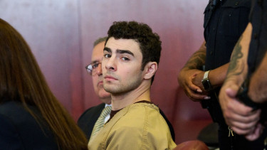 Luigi cleared of terror charges, murder trial continues