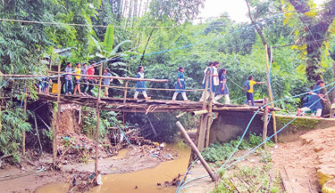 Slow pace of a bridge construction in Bandarban Municipality causes hardship for approximately 6,000 villagers. The previous bridge was demolished last year to facilitate the new one; however, work has remained suspended due to the contractor’s negligence. Besides, the temporary culvert made of bamboo and wood has deteriorated significantly, posing serious risks to the community.    -   FOCUS BANGLA PHOTO