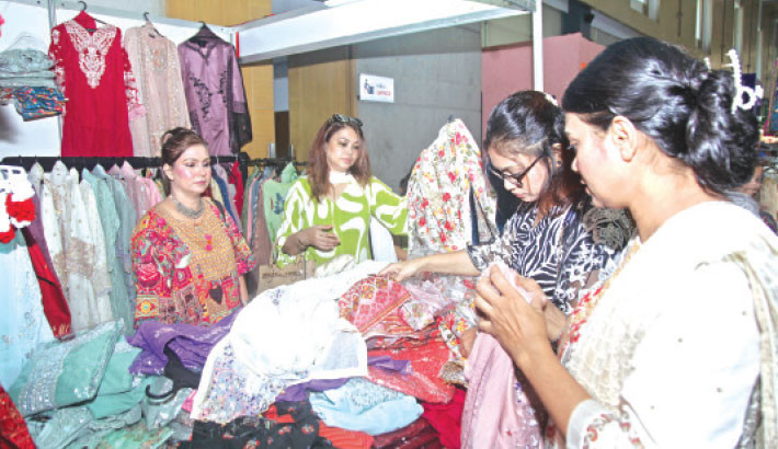 Visitors browse products at a stall during the South Asia Trade Fair 2025 at the International Convention City Bashundhara (ICCB) in the capital on Friday. The four-day event features over 100 companies from SAARC countries showcasing a wide range of products and services. -Daily sun Photo