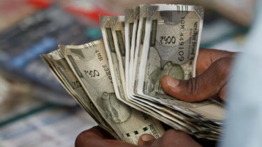 India rupee at record low, but options market is not sweating the swings