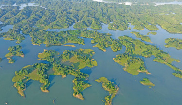 Emerald-green islands float on the tranquil blue waters of the stunning Kaptai Lake in Rangamati. Renowned for its natural beauty, Rangamati is a popular tourist destination, with Kaptai Lake as one of its main attractions. The photo was taken on Thursday.  	-SM MOSTAFIJUR RAHMAN