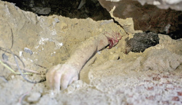 The body of a child lies buried under the rubble of a building hit by an Israeli strike in the Nuseirat refugee camp in the central Gaza Strip, on Thursday, as Israel presses its air and ground offensive to capture the nearby Gaza City.	- AFP PHOTO