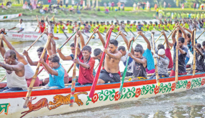 Competitors row vibrantly decorated boats along the Ghaghat River in Sadar Upazila of Gaibandha on Sunday, as the fierce energy of the two-day race and the cheers of the crowd enliven the waters. Focus bangla