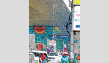 Commuters get suddenly drenched and traffic gets disrupted as broken water delivery pipes under the Mouchak-Moghbazar flyover gush water following a rain on Tuesday. -Kamrul Islam Ratan