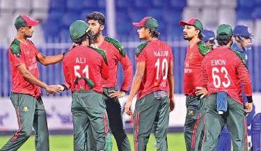 Bangladesh players celebrate taking an Afghanistan wicket during the second T20I at the Sharjah Cricket Stadium on Friday. The Tigers restricted Afghanistan to 147/5 after sending them to bat first.  -  ACB PHOTO