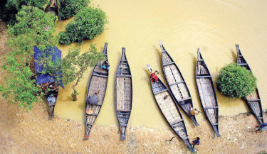 A number of boats are moored along the shore of Ratargul Swamp Forest, a freshwater wetland situated on the River Gowain in Gowainghat upazila of Sylhet. The forest remains submerged under water for five to six months each year. During this period, thousands of tourists visit the majestic site to experience and admire its natural beauty. 

-BAPPA MOITRA