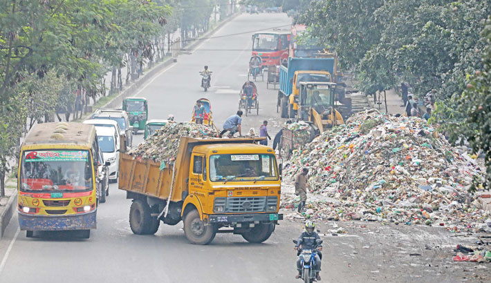 Cleaning workers under the Dhaka North City Corporation dispose of garbage on the Nadda-Coca-Cola main road, posing a threat to the environment. The photo was taken on Saturday. -Kamrul Islam Ratan