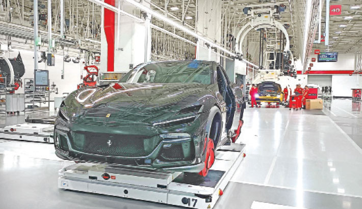 This photograph shows a view of the production line inside the Ferrari’s factory in Maranello, on Thursday. Ferrari will begin its cautious shift to electric vehicles in 2026 with its first battery-powered four-seat coupe, but shares plummeted on 9 October 2025 over a long-term profit outlook that fell short. Photo: AFP