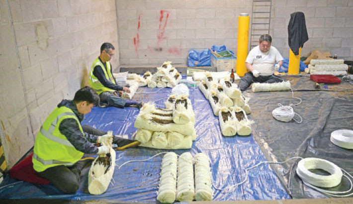 Construction of the shobu-dawara, the straw bales that form an edging to the sumo ring, the dohyo, as preparations are underway inside the Royal Albert Hall in central London on 12 October 2025, ahead of the Grand Sumo Tournament being held over five days in London from October 15th. Over 40 of Japan’s elite maku-uchi rikishi (wrestlers) will compete in London this week, bringing with them the 1,500-year legacy of Sumo. Photo: AFP