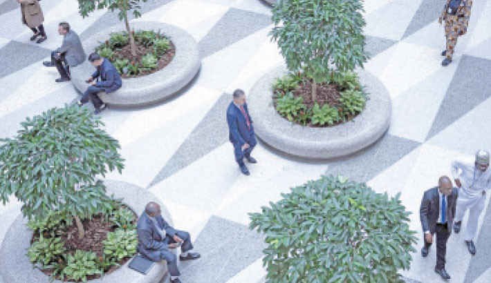 People walk through the International Monetary Fund’s headquarters during the World Bank Group and IMF’s annual meetings 13 October 2025, in Washington, DC. The IMF and World Bank’s semi-annual gathering of finance ministers and central bank governors got underway in Washington on Monday, against the backdrop of new trade threats between the world’s two largest economies. Photo: AFP