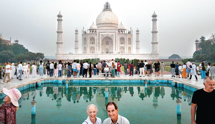 Tourists visit the Taj Mahal at sunrise in Agra on 18 October 2025. PHOTO: AFP