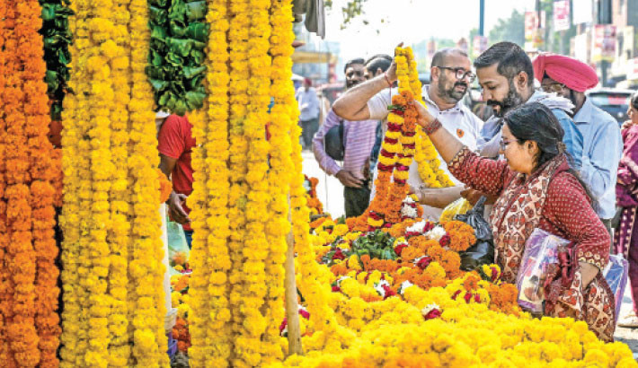Floral vendors sell marigold garlands on the occasion of ‘Diwali’, the Hindu festival of lights along a street in Amritsar, India, on Monday. PHOTO: AFP