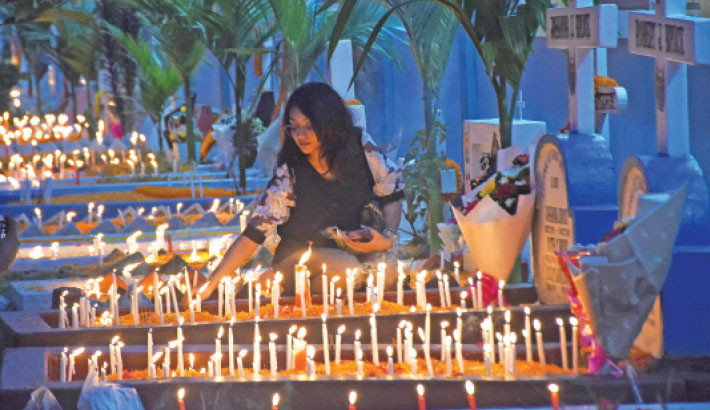 A woman lights candles and offers prayers at the Patharghata Catholic Church cemetery in Chattogram on Sunday, marking All Souls’ Day -- a time to remember loved ones and pray for the peace of departed souls. 


-Rabin chowdhury