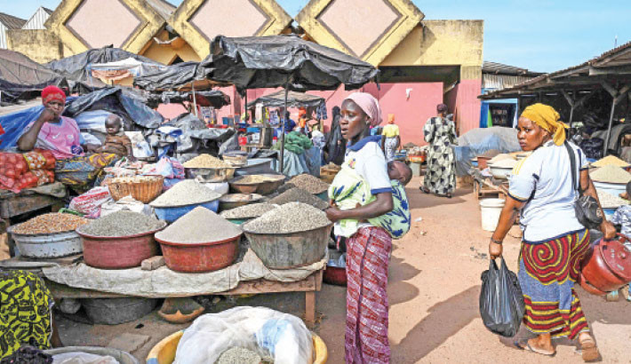 Customers shop at a market in Tengrela, northern Ivory Coast near the Mali border, on 31 October 2025. Photo: AFP