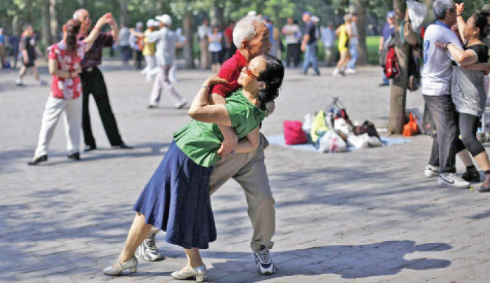 Locals dance during a morning exercise session at the Temple of Heaven park in Beijing.