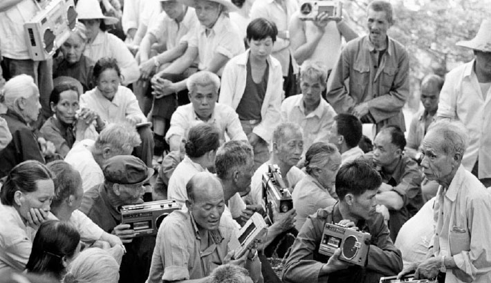 Residents hold tape recorders to record folk songs during a singing contest in Guilin, Guangxi Zhuang autonomous region in 1988.