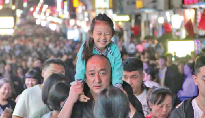 A girl celebrates the golden week national holiday with her dad in October 2018