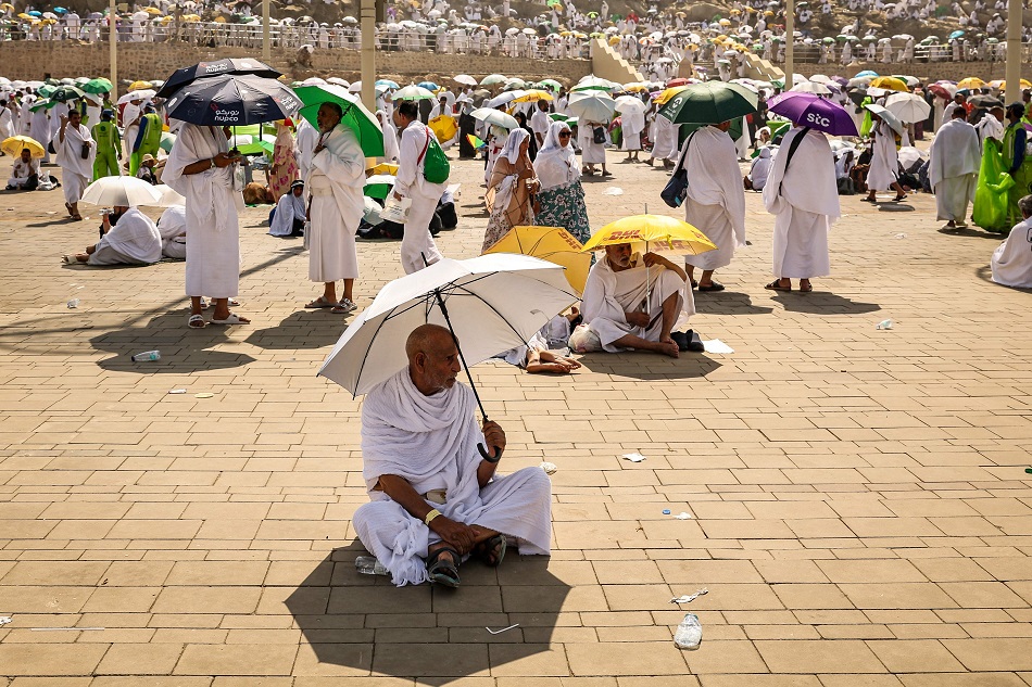 Muslim pilgrims use umbrellas to shade themselves from the sun as they arrive at the base of Mount Arafat, also known as Jabal al-Rahma or Mount of Mercy, during the annual hajj pilgrimage on 15 June. Photo: AFP